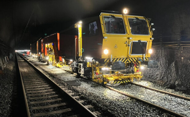 A tamping machine at work inside the Severn Tunnel.