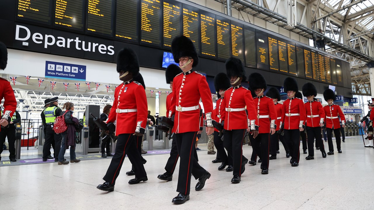 Military personnel marching through London Waterloo station on the day of the coronation of King Charles III.