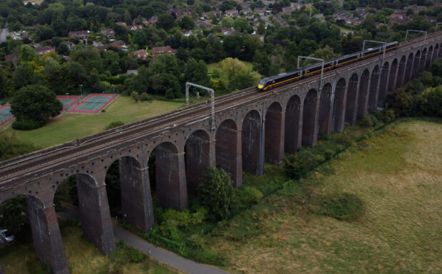 Aerial image of a train testing digital in-cab signalling across a viaduct.